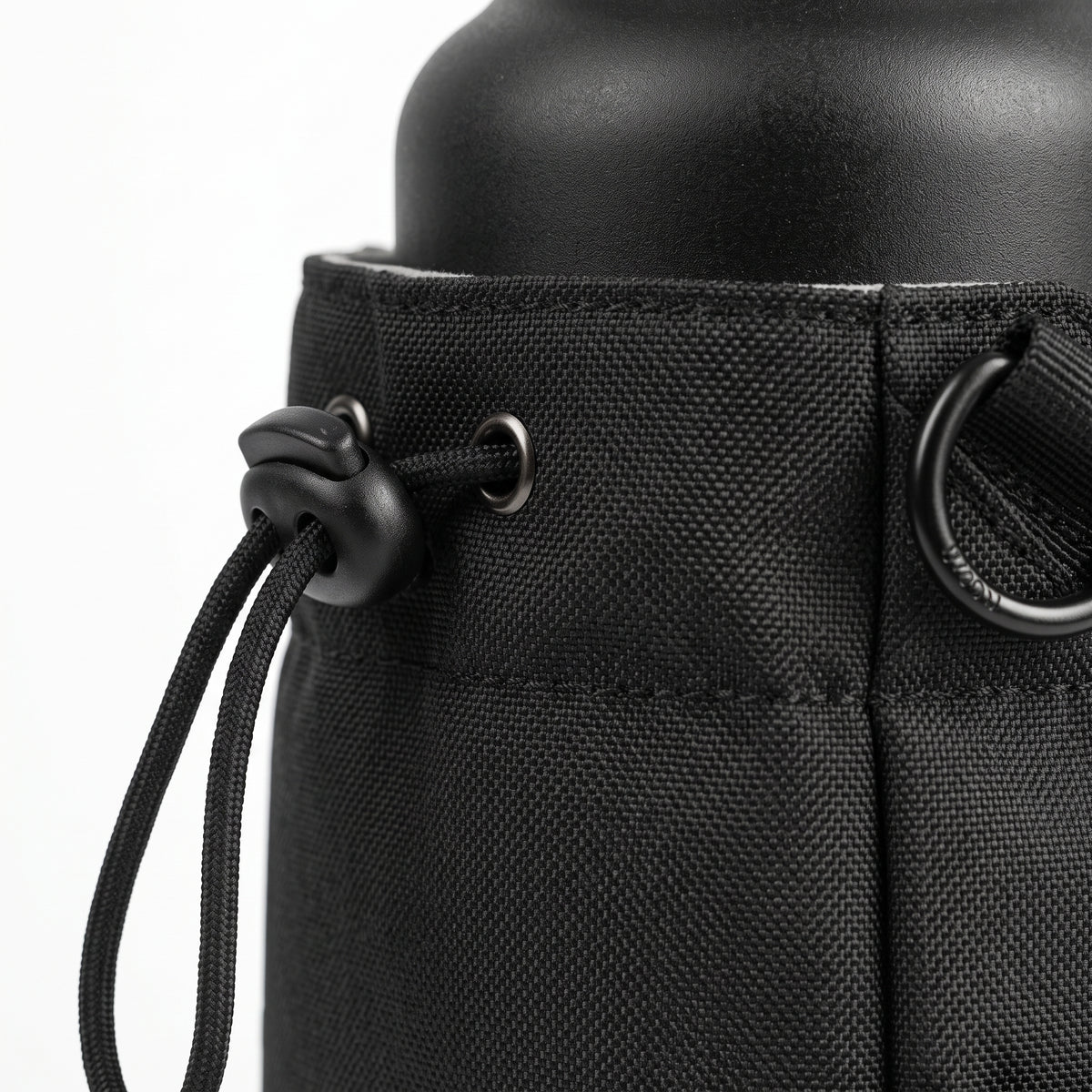 A tight macro close-up shot focusing on the ballistic nylon fabric texture, detailed stitching, and one of the strong embedded magnetic discs of the Aveliques Magnetic Gym Bag.