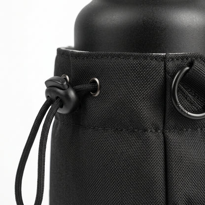 A tight macro close-up shot focusing on the ballistic nylon fabric texture, detailed stitching, and one of the strong embedded magnetic discs of the Aveliques Magnetic Gym Bag.